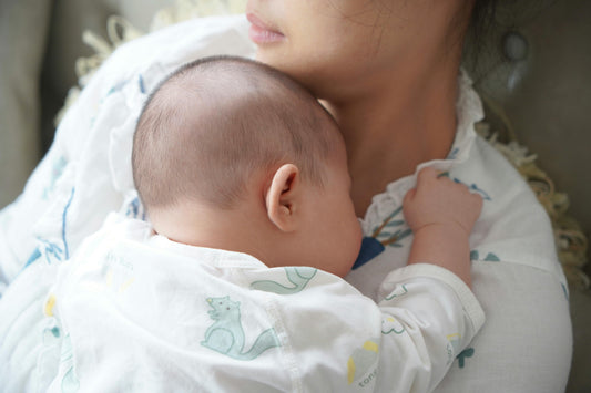 Mother holding sleeping newborn baby