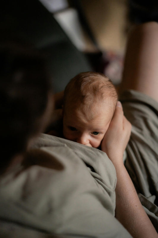 Newborn baby resting peacefully on a soft surface
